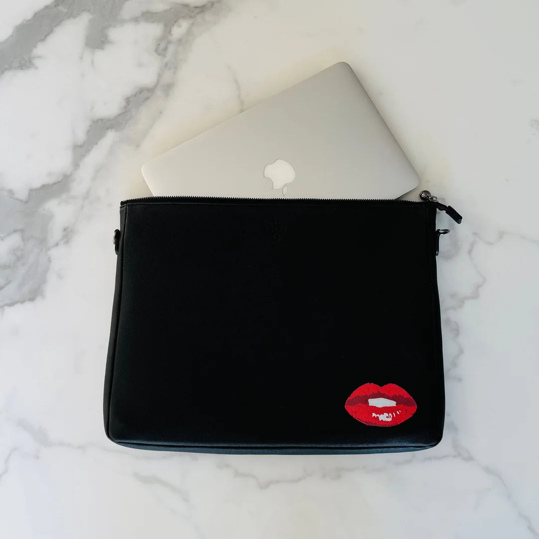 Black #9 JW Blackout Lips padded techie crossbody holding a laptop on marble