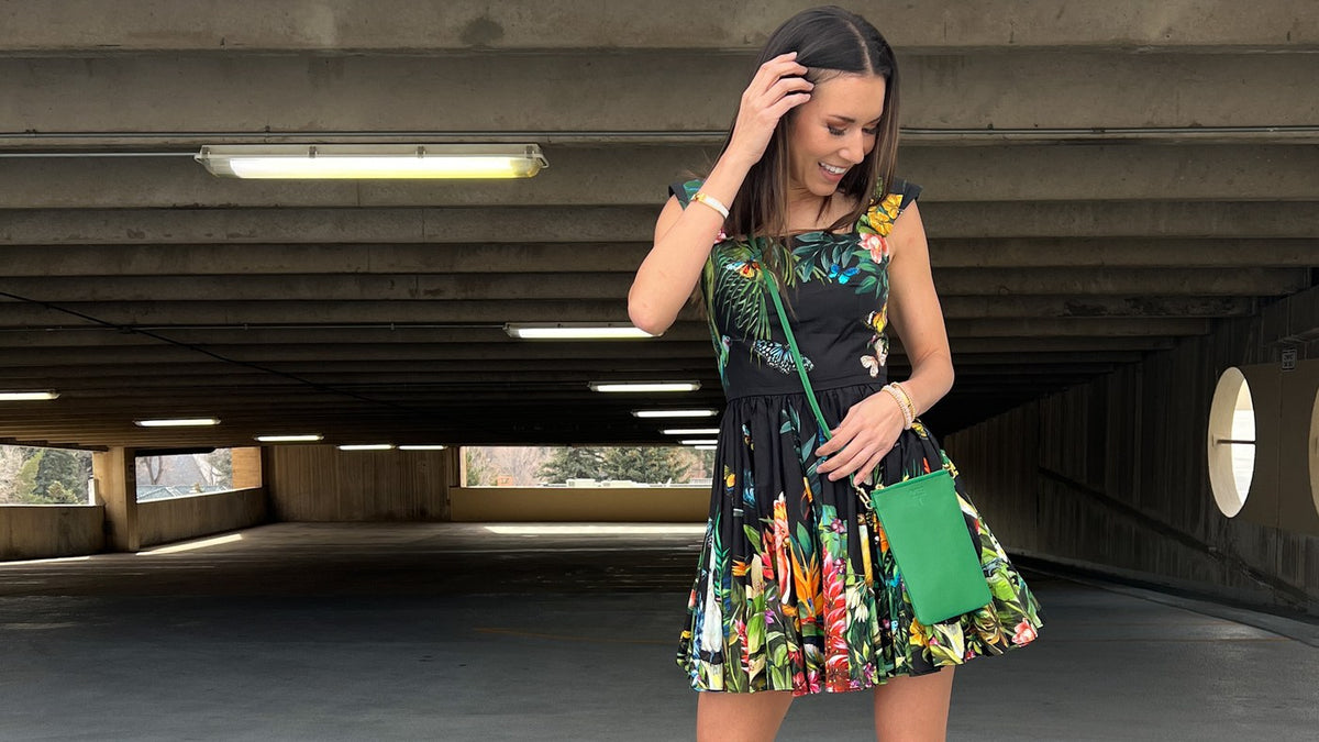 Woman carrying a green OTG|247 #1 crossbody wristlet
